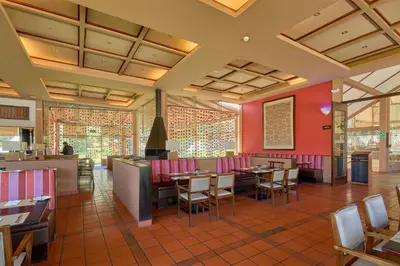 a restaurant with red walls and tables and chairs at Casa Andina Premium Valle Sagrado Hotel & Villas in Urubamba