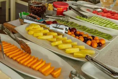 two trays of fruit and vegetables on a table at Cozy Room Cusco in Cusco