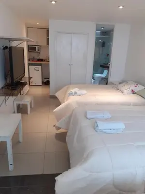a hotel room with two beds and a kitchen at Monterrico Suites Hotel in Lima