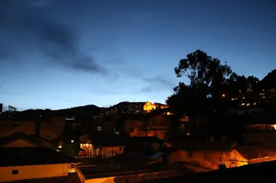 a view of a city at night at Hotel & Mirador Los Apus in Cusco