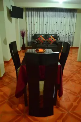 a dining room with a table and a couch at Rosenverg B&B Tours in Lima
