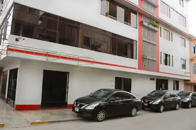 three cars parked in front of a building at Rosenverg B&B Tours in Lima