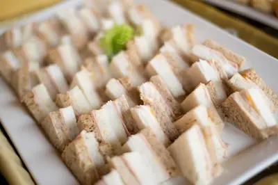 a white plate with a bunch of sandwiches on it at Decameron El Pueblo in Lima