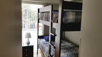 a room with two bunk beds and a window at Miraflores Modern Baja Balta in Lima