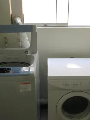 a washing machine and a washer in a room at Miraflores Modern Baja Balta in Lima