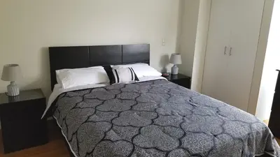 a bedroom with a large bed with a black headboard at Miraflores Modern Baja Balta in Lima
