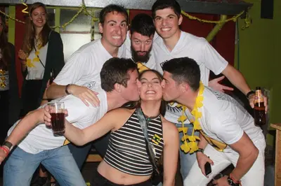 a group of men posing for a picture at a party at Blacky Hostel and Apartments in Cusco