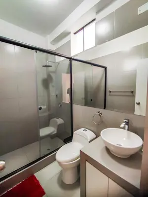 a bathroom with a toilet and a sink and a shower at Resort la Fogata Cieneguilla in Cieneguilla