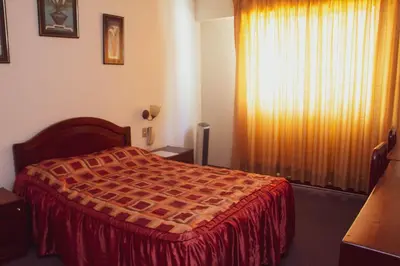 a hotel room with a bed and a window at Hotel Internacional in Lima