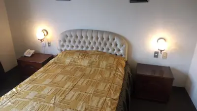 a bedroom with a large bed with two night stands at Hotel Internacional in Lima
