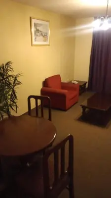a living room with a red couch and a table at Hotel Internacional in Lima