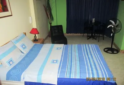 a bedroom with a bed and a chair and a desk at Septima Maravilla in Lima