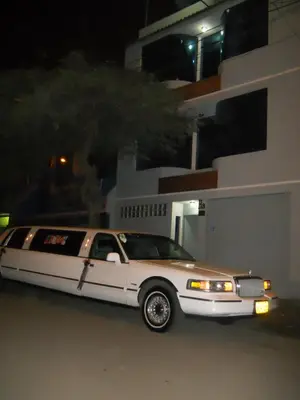 a white limousine parked in front of a house at Septima Maravilla in Lima