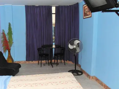 a room with a table and chairs and a window at Septima Maravilla in Lima