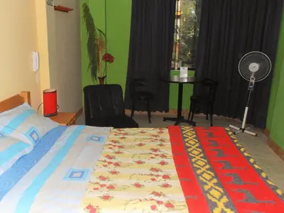 a bedroom with a bed and a room with a fan at Septima Maravilla in Lima