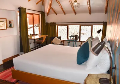 a bedroom with a bed with a lamp on it at Nodo Cusco Garcilaso in Cusco