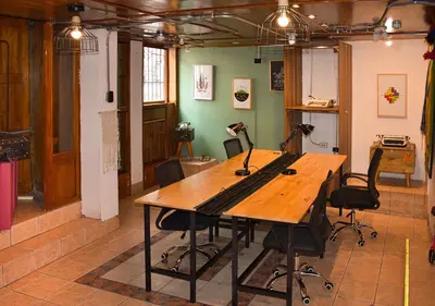 a room with a wooden table and chairs at Nodo Cusco Garcilaso in Cusco