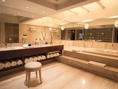 a bathroom with a tub and a sink and a stool at Swissotel Lima in Lima