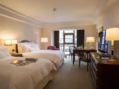 a hotel room with two beds and a television at Swissotel Lima in Lima
