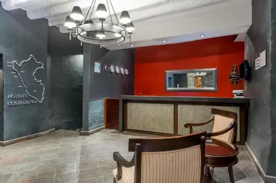 a bar in a restaurant with red walls at Wyndham Costa del Sol Cusco in Cusco