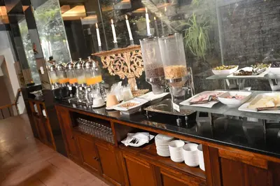 a buffet line with plates of food and drinks at Wyndham Costa del Sol Cusco in Cusco