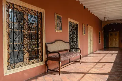 a bench sitting on the side of a building at Wyndham Costa del Sol Cusco in Cusco