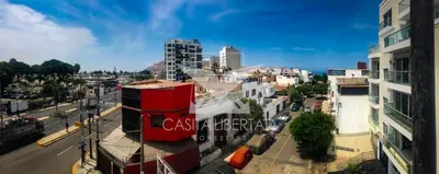 an aerial view of a city with buildings and a street at Casita Libertad Chorrillos in Lima