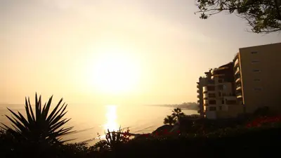 a sunset over a body of water with buildings at Casita Libertad Chorrillos in Lima
