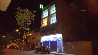 a car parked in front of a building at night at Hotel Shelter in Huancayo