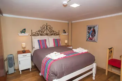 a bedroom with a bed with two towels on it at Casa Saphi in Cusco
