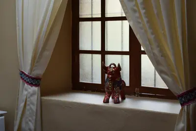 a small figurine sitting on a window sill at Casa Saphi in Cusco