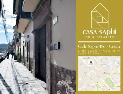 a sign on the side of a building next to a street at Casa Saphi in Cusco