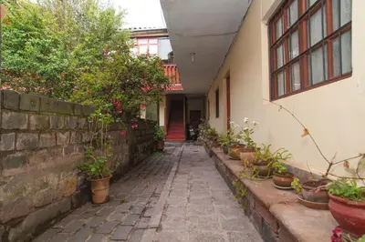 a walkway with potted plants on the side of a building at Casa Saphi in Cusco