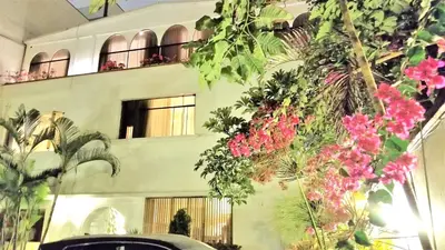 a building with pink flowers in front of it at Casa Bella Boutique Hotel San Isidro in Lima