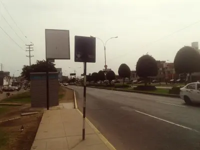 two street signs on the side of a road at La Casa del Che Fernando in Lima