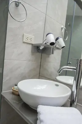 a bathroom with a white sink and a mirror at Casa Cavassa Centro Histórico Cusco in Cusco