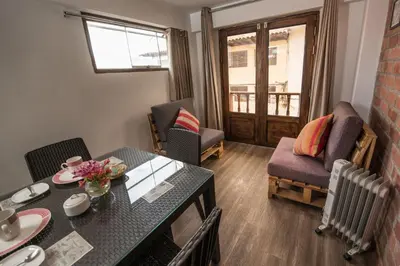 a small living room with a table and chairs at Casa Cavassa Centro Histórico Cusco in Cusco