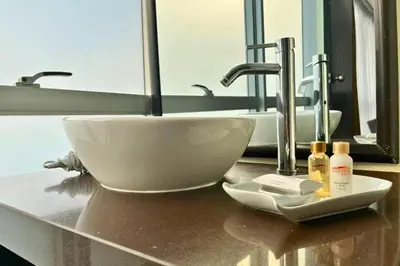 a bathroom sink with two sinks and two faucets at Allpa Hotel & Suites in Lima