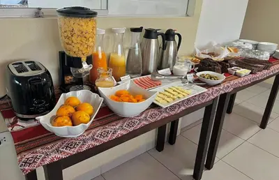 a table with bowls of oranges and other food on it at Hostal Casona Arrambide in Cusco