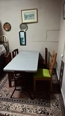 a white dining room table and chairs on a rug at Habitaciones para Estudiantes Y/o Mochileros in Lima
