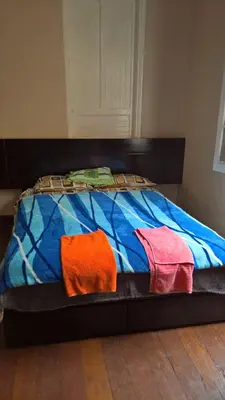 a bed with two towels on top of it at Habitaciones para Estudiantes Y/o Mochileros in Lima