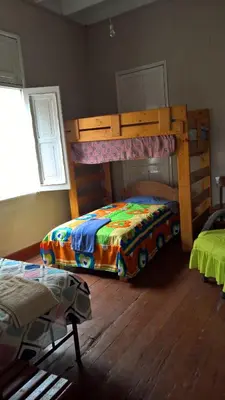a bedroom with a bunk bed with a colorful blanket at Habitaciones para Estudiantes Y/o Mochileros in Lima