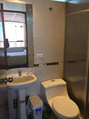 a small bathroom with a toilet and a sink at Edmoli Casa Hospedaje in Cusco