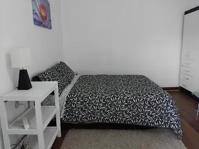 a bedroom with a bed with a black and white bedspread at Studio in historic center Cusco in Cusco