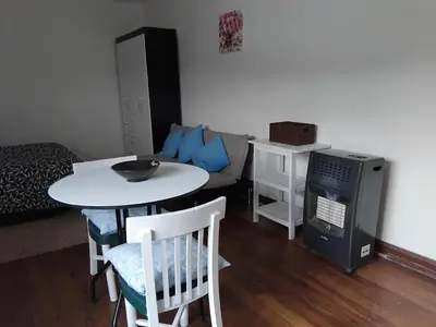 a small living room with a table and a couch at Studio in historic center Cusco in Cusco
