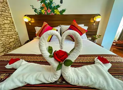 two swans made out of towels on a bed at Hotel Machupicchu Adventure in Machu Picchu