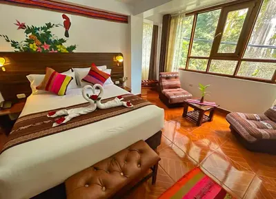 a bedroom with a large bed with towels on it at Hotel Machupicchu Adventure in Machu Picchu