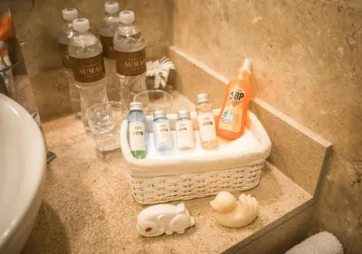 a bathroom counter with bottles of soap and a basket at Sumaq Machu Picchu Hotel in Machu Picchu