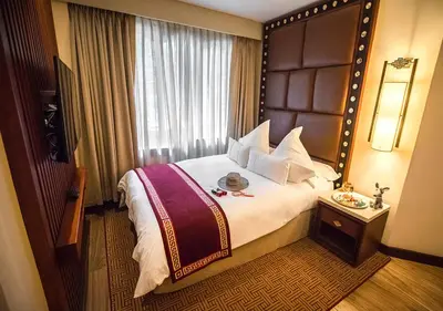 a hotel room with a large bed and a window at Sumaq Machu Picchu Hotel in Machu Picchu
