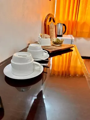 a table with plates and bowls on top of it at Mama's House in Cusco
